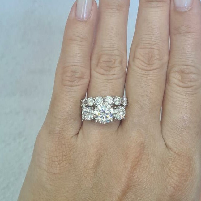 White gold round three stone moissanite engagement ring with matching wedding band