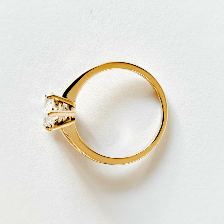 Ruth pear cut solitaire moissanite ring with five prongs set in yellow gold
