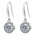 Hook earring set with a round moissanite surrounded by a halo of smaller moissanites, in sterling silver