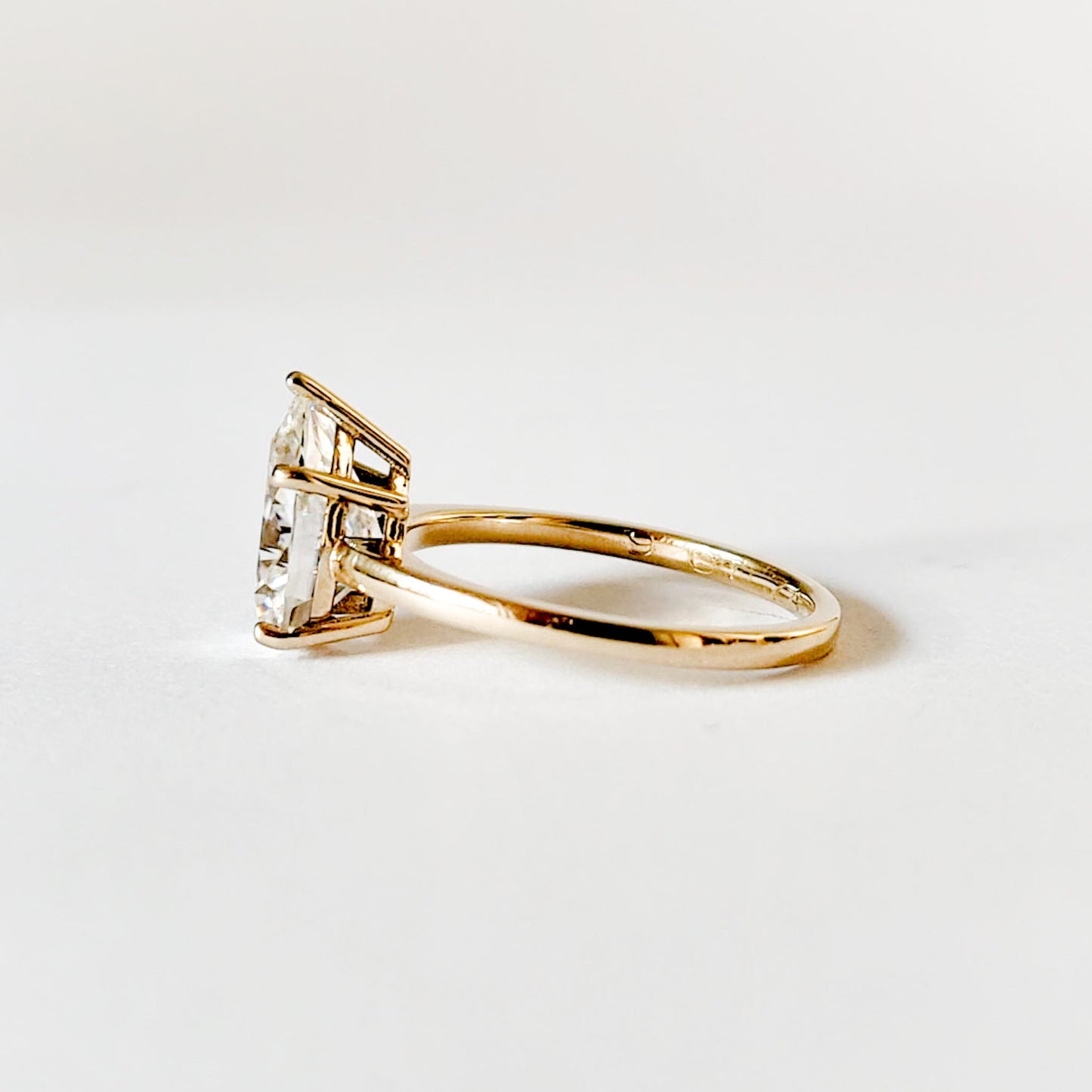 Ruth pear cut solitaire moissanite ring with five prongs set in yellow gold
