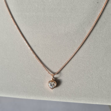 1 carat heart shaped moissanite pendant in a bezel setting on a 9ct rose gold necklace chain