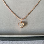 1 carat heart shaped moissanite pendant in a bezel setting on a 9ct rose gold necklace chain