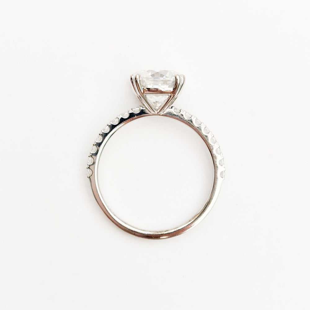 Square cushion cut moissanite engagement ring with double claws on a micropave band in white gold