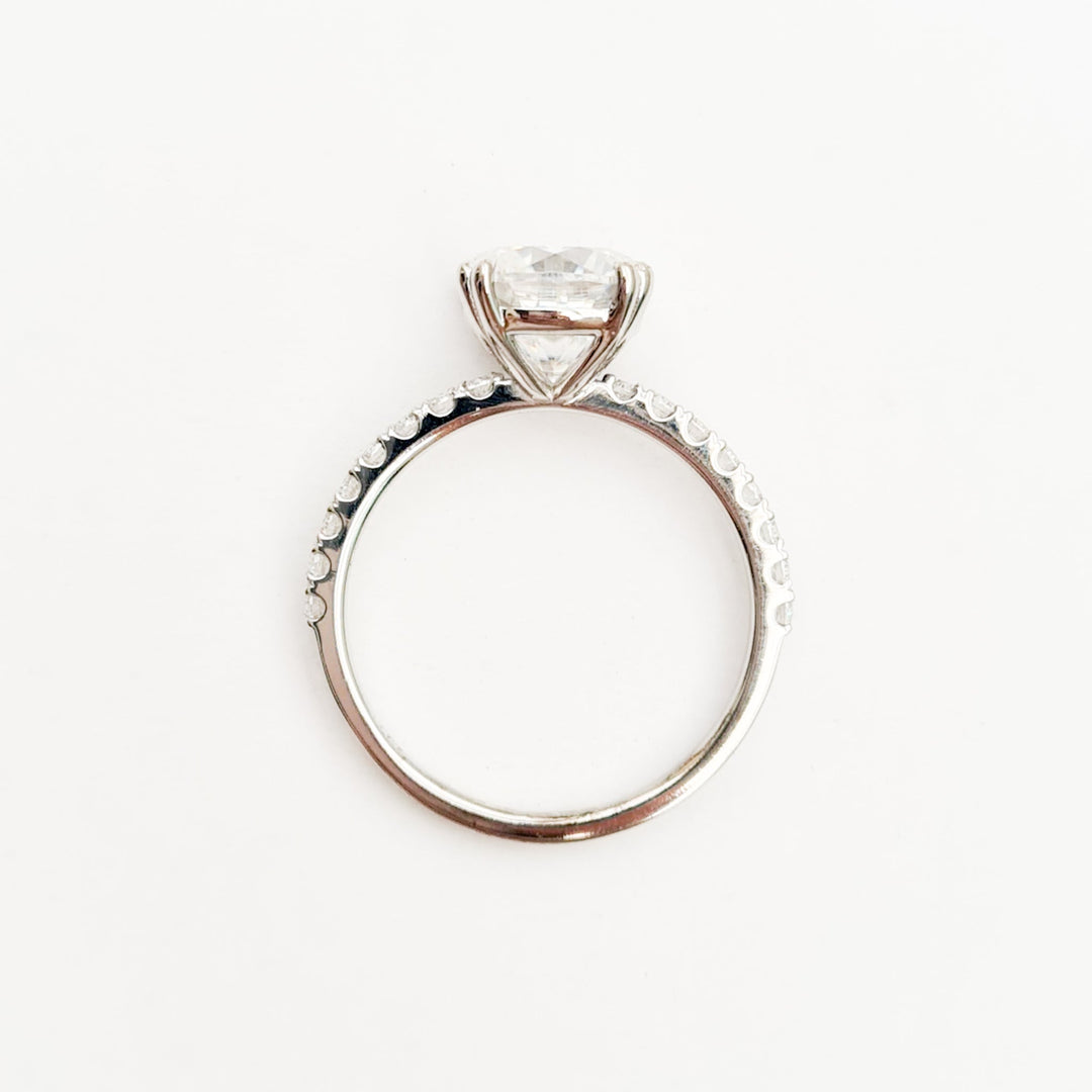 Square cushion cut moissanite engagement ring with double claws on a micropave band in white gold