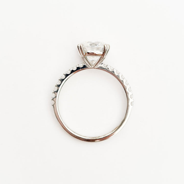 Square cushion cut moissanite engagement ring with double claws on a micropave band in white gold