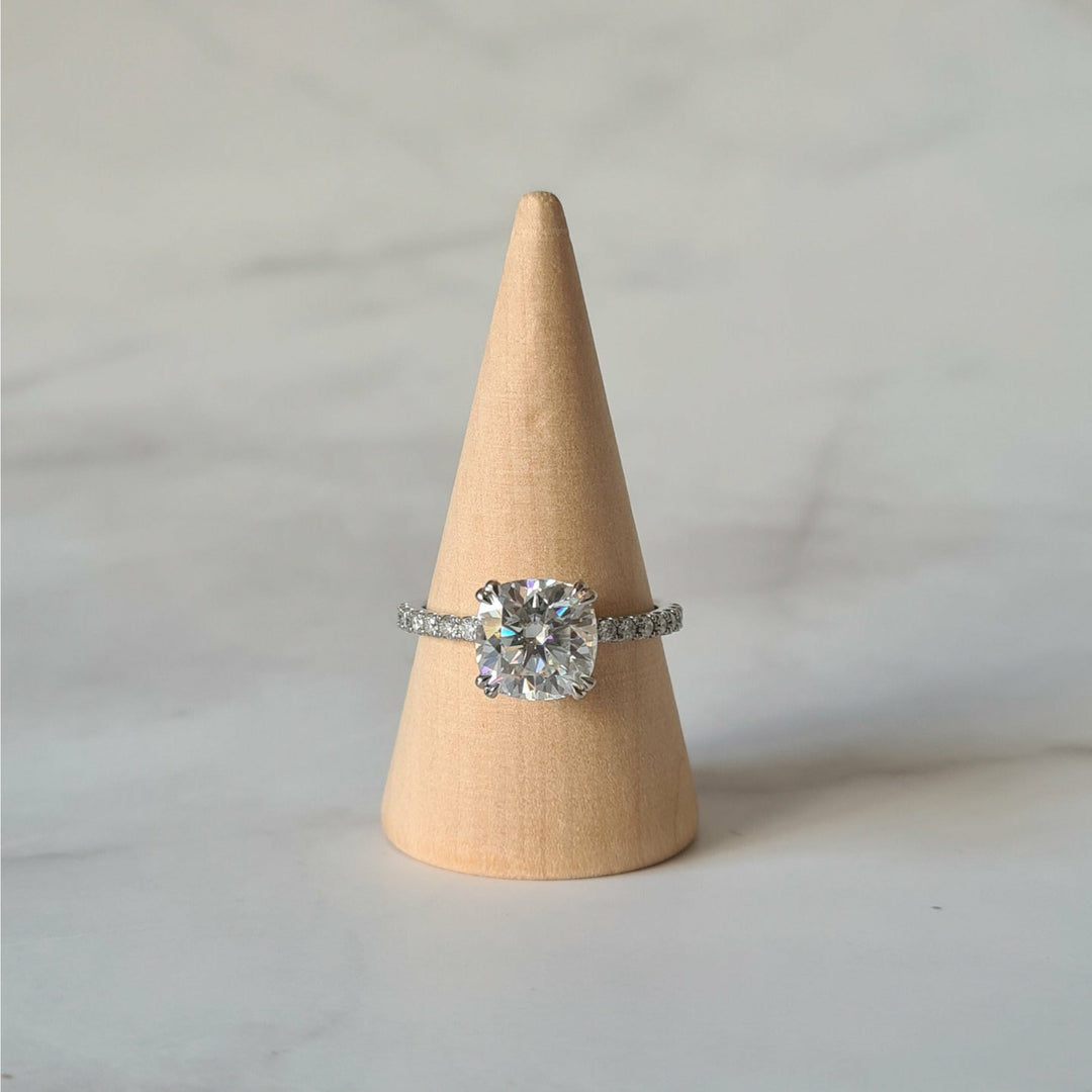 Square cushion cut moissanite engagement ring with double claws on a micropave band in white gold