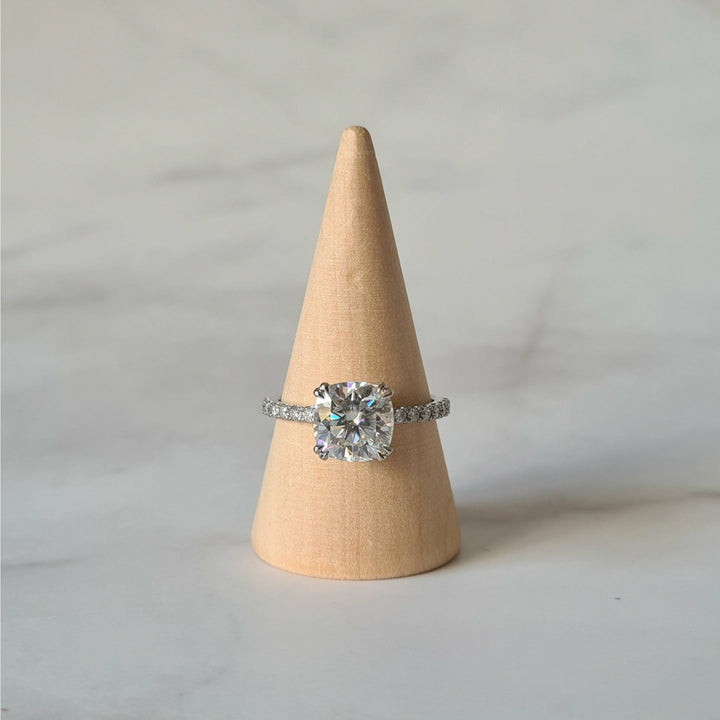 Square cushion cut moissanite engagement ring with double claws on a micropave band in white gold