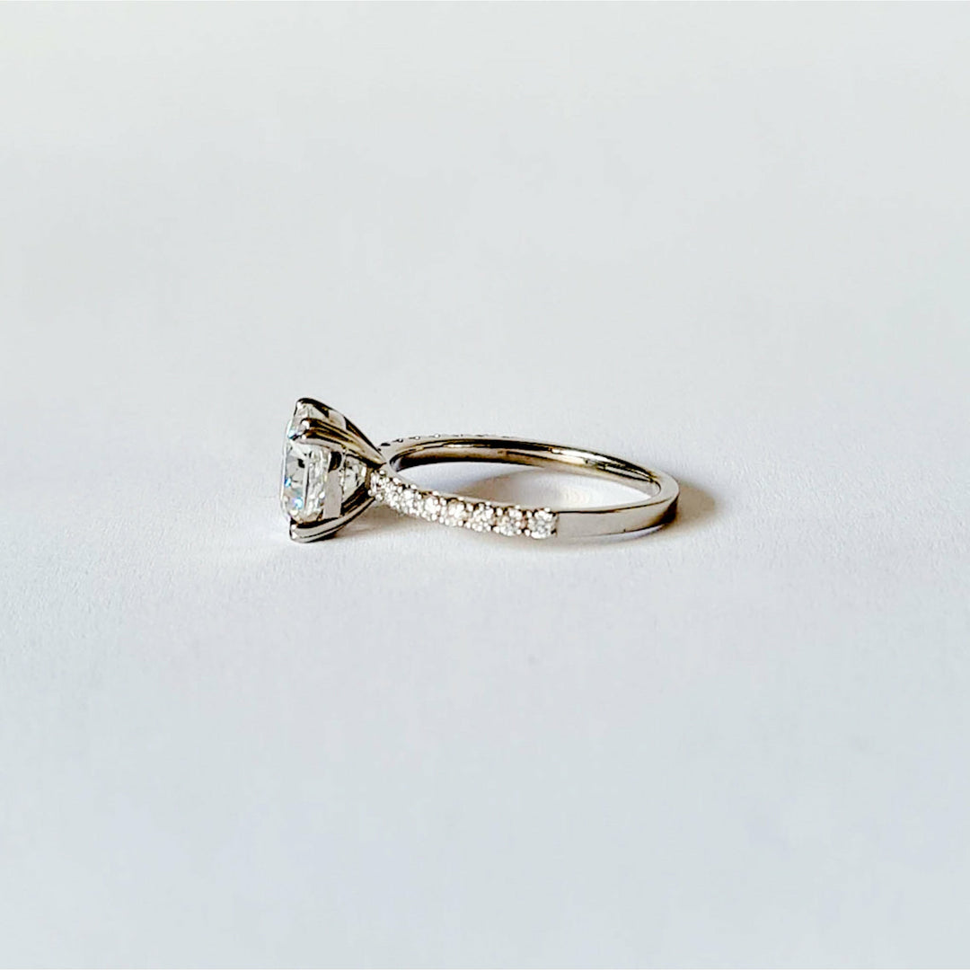 Square cushion cut moissanite engagement ring with double claws on a micropave band in white gold
