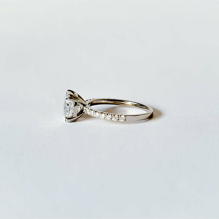 Square cushion cut moissanite engagement ring with double claws on a micropave band in white gold