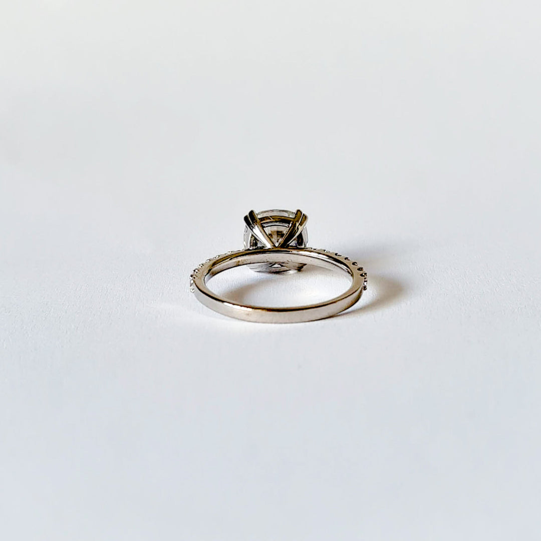 Square cushion cut moissanite engagement ring with double claws on a micropave band in white gold