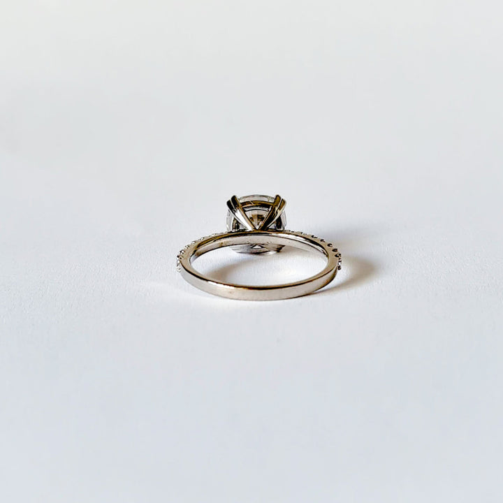 Square cushion cut moissanite engagement ring with double claws on a micropave band in white gold