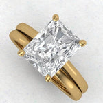 3ct radiant cut moissanite solitaire engagement ring in yellow gold with matching wedding band